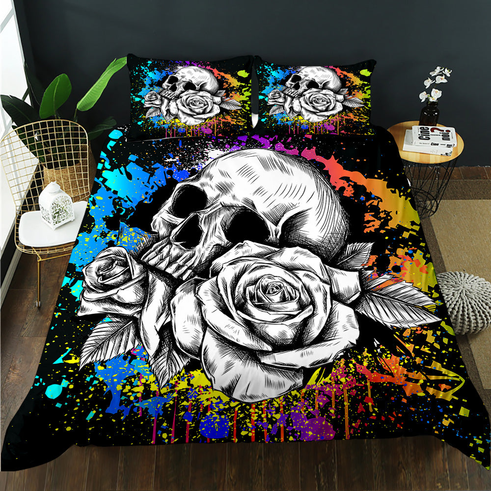 Sketched skull and roses over rainbow paint splatter on a black quilt cover set