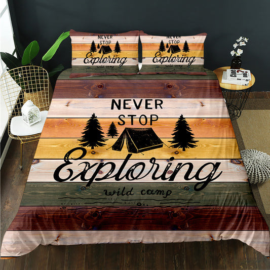 Bedding set with 'Never Stop Exploring' design on a bed in a room setting.